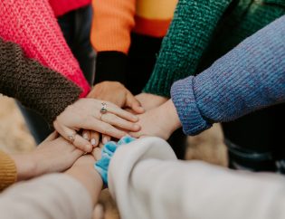 A group of women with their hands piled together. There are several levels of care in addiction treatment. Twin Branch Wellness & Recovery is a Residential Treatment Program.