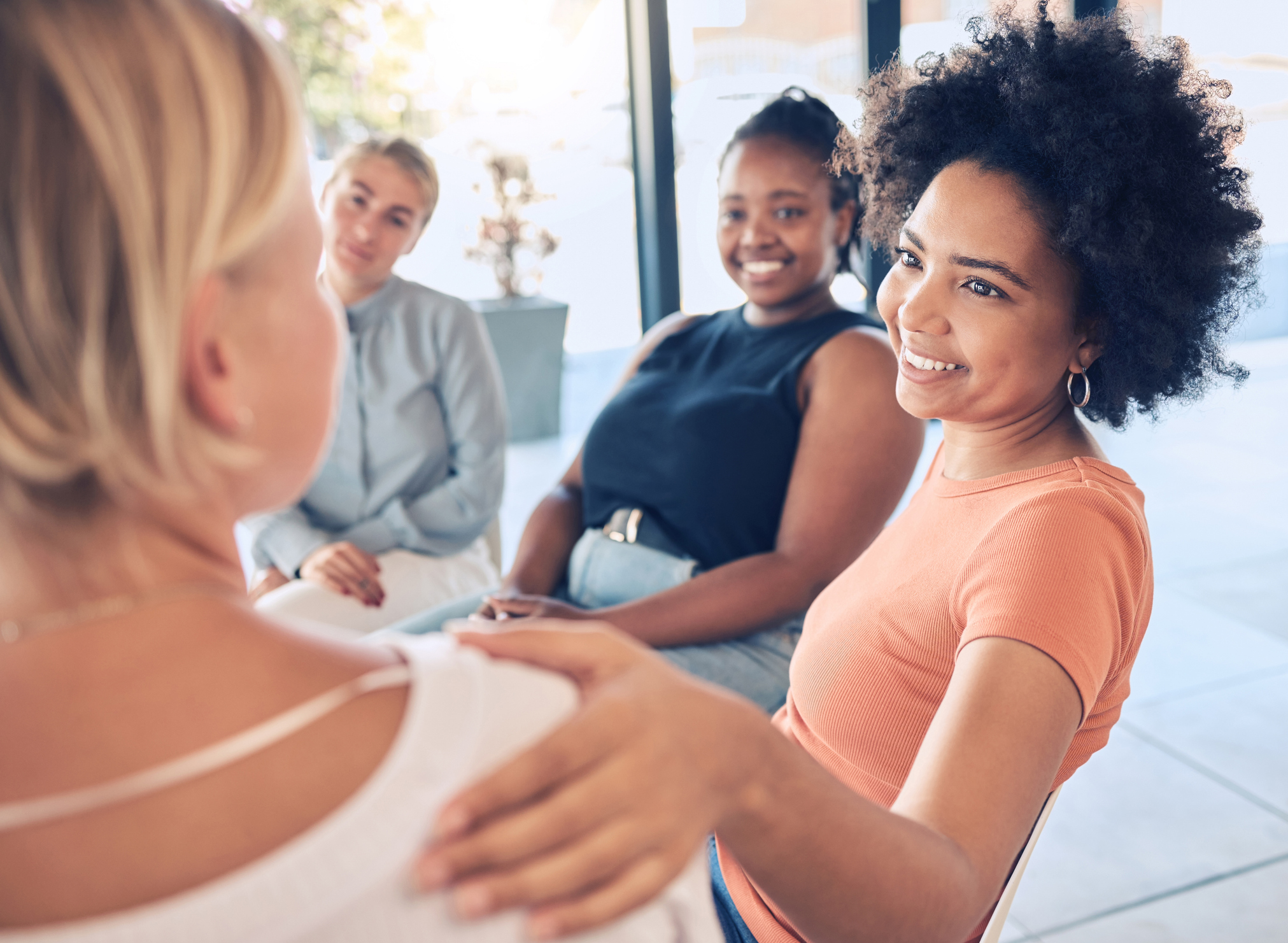 group of women in therapy addressing their mental health challenges.