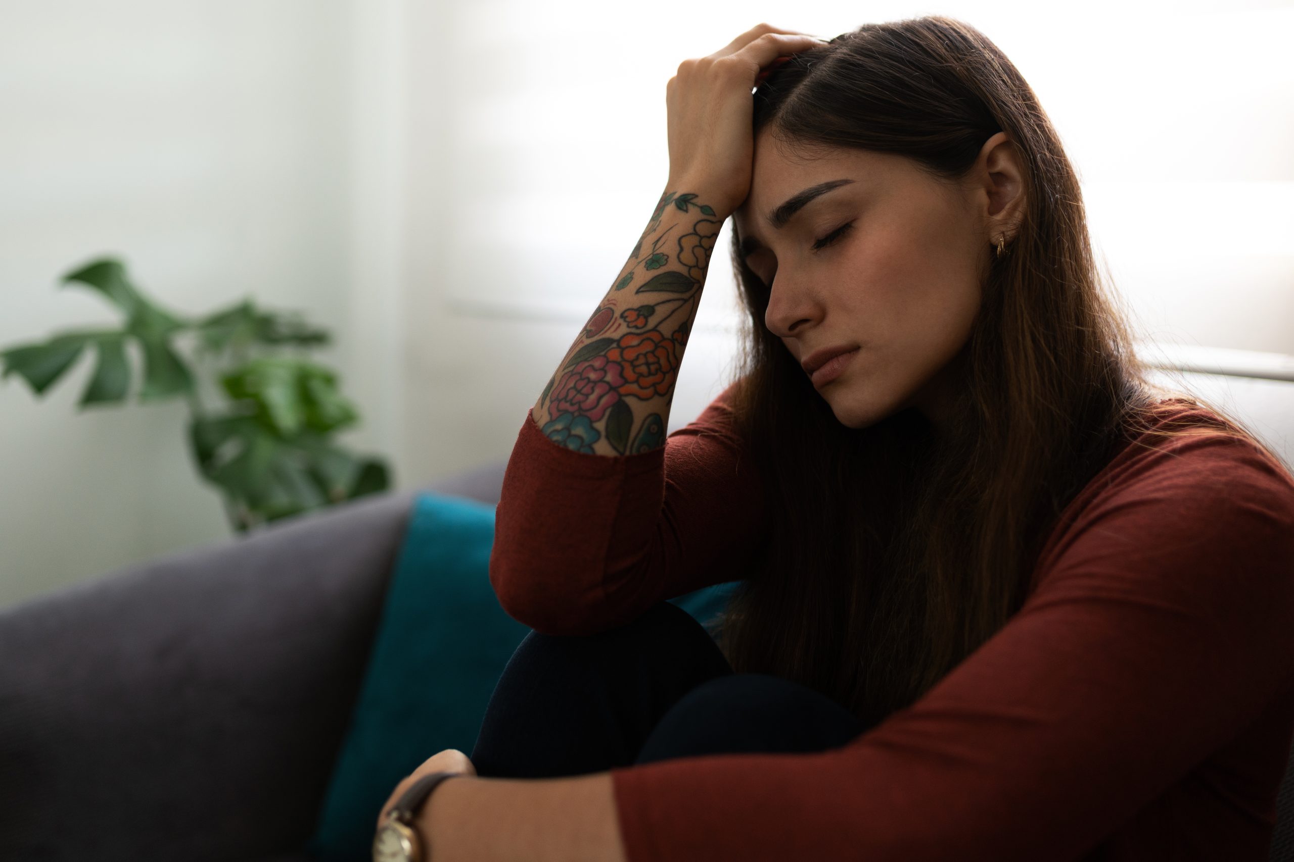 trauma response in women, an upset woman with her hand on her head.