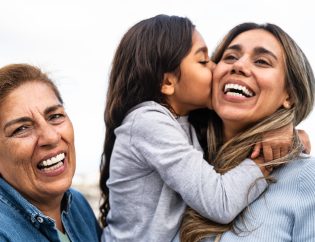 breaking generational trauma; a grandmother, mother, and daughter, three generations, all smiling